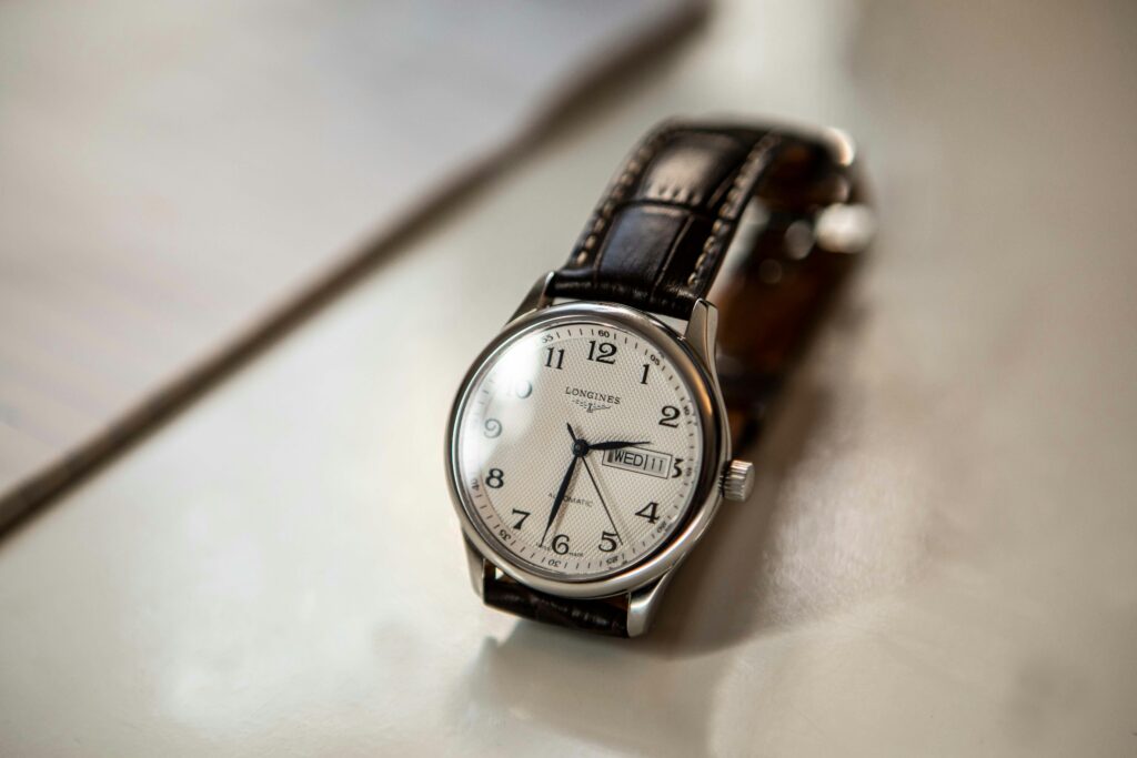 Close-up of a classic Longines luxury wristwatch with leather strap and elegant design.